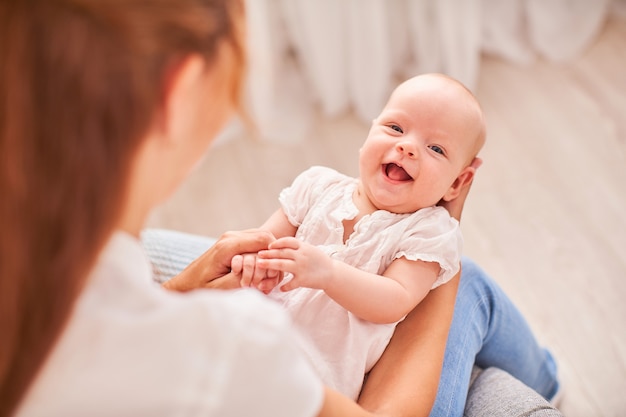 Gymnastics baby. woman doing exercises with baby for its development. massage a small newborn baby.