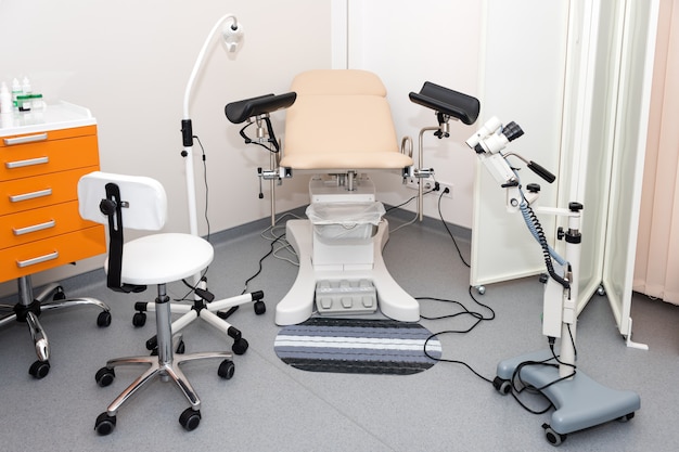 Gynecological cabinet with chair and other medical equipment in modern clinic