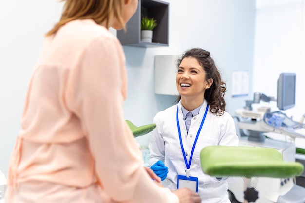 Gynecologist talking with young female patient during medical consultation in modern clinic Patient with a gynecologist during the consultation in the gynecological office