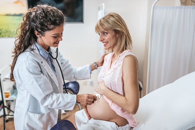 Gynecology examination and consultation. Pregnant woman with her doctor at clinic.