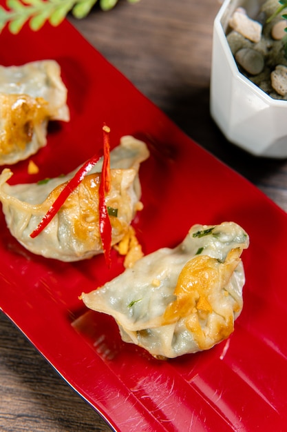 Gyoza are identical to jiaozi made in Chinese households using store bought machine made wrappers