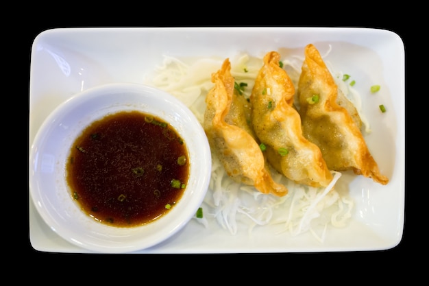 Gyoza or dumplings on white plate, focus selective.