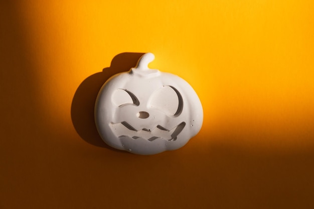 Gypsum figure of a Halloween pumpkin on a colored background