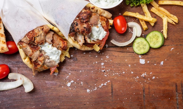 Gyro pita shawarma take away street food Traditional greek turkish meat food on wooden table