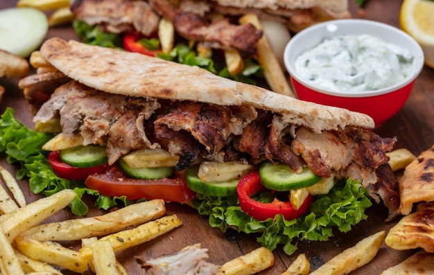 Gyros shawarma take away street food Sandwich with meat on wooden table