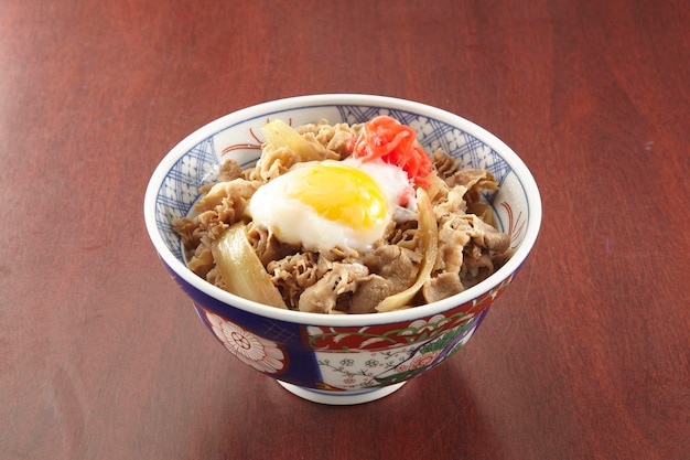 Gyu Don with egg served in a dish isolated on wooden table side view of singapore food