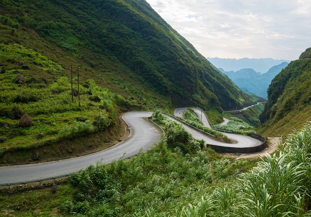 Ha Giang karst geopark mountain landscape in North Vietnam. Winding road in stunning scenery. Ha Giang motorbike loop, famous travel destination bikers easy riders.