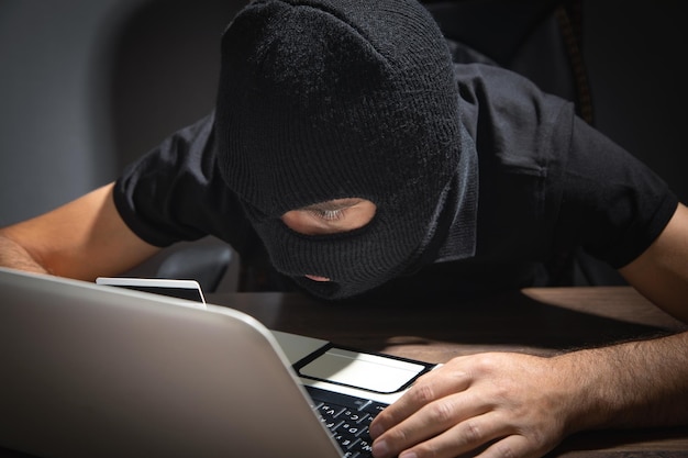 Hacker stealing information from the office computer Hacking Criminal