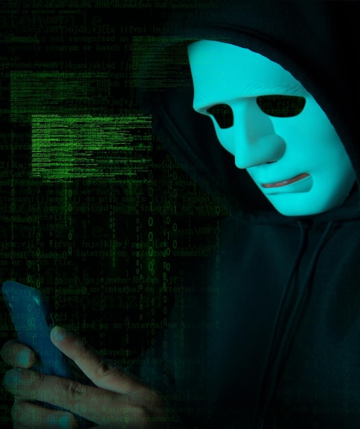 Hacker wearing white mask with binary code digital interface Using smartphone to steal financial data Double exposure data theft internet fraud darknet and cyber security concept