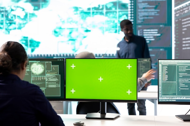 Hackers team working with a green screen layout on computer in monitoring room