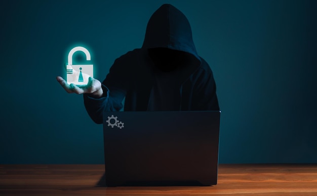 Hackers work on laptops in the dark The concept of information security in the Internet network .