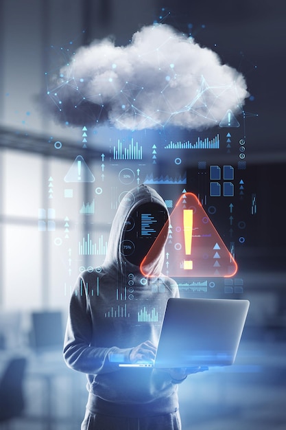 Hacking and internet security concept with faceless person in hoody with laptop in hands and abstract digital data cloud network interface with exclamation point double exposure