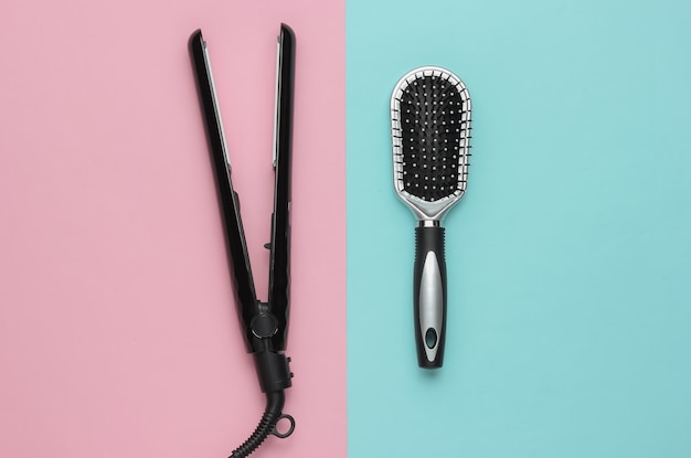 Hair care Beauty studio shot Hair iron comb on  pink blue background