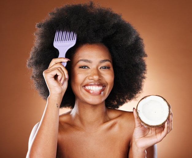 Hair care comb and portrait girl with coconut for afro hair growth healthy hair hydration or moisturizing hairstyle treatment Fruit product wellness and face of black woman with natural routine