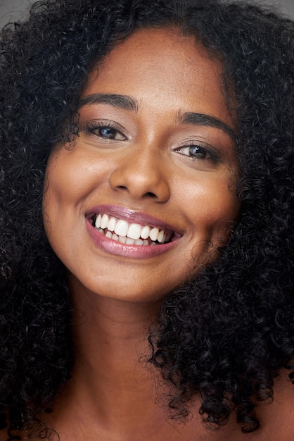 Hair care portrait and smile of a woman with beauty skincare and makeup Face of a young happy and African girl model with cosmetics happiness with dental teeth and facial dermatology care