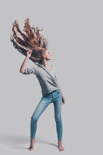 Photo hair like fire. full length studio shot of attractive young woman with tousled hair posing