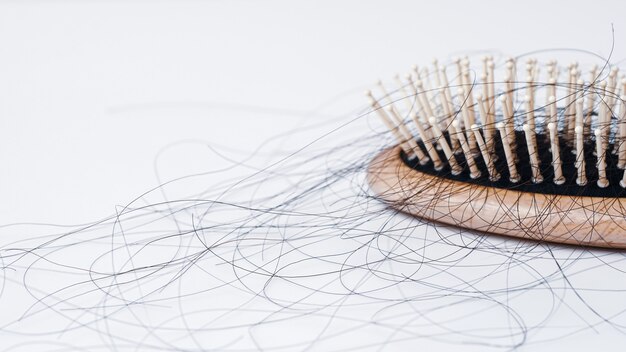 Hair loss in comb hair fall everyday serious problem on white background