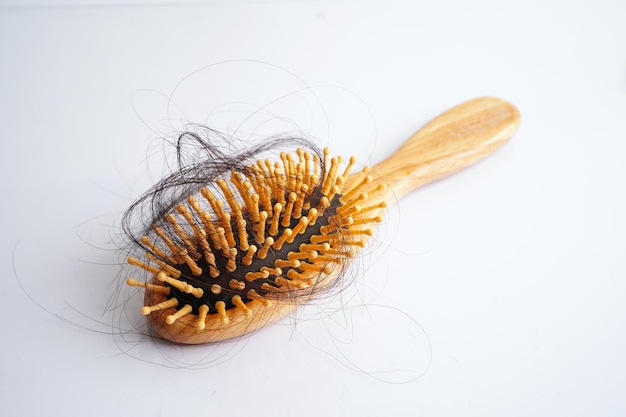 Hair loss fall with comb brush isolated on white background