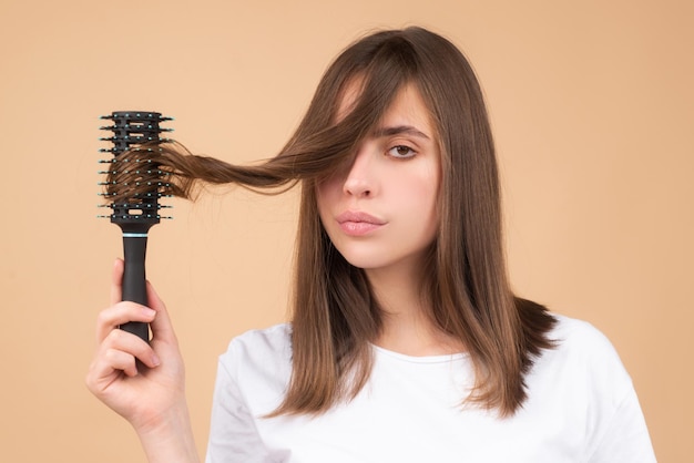 Hair loss woman with a comb and problem hair hairloss stressed woman and bald problems