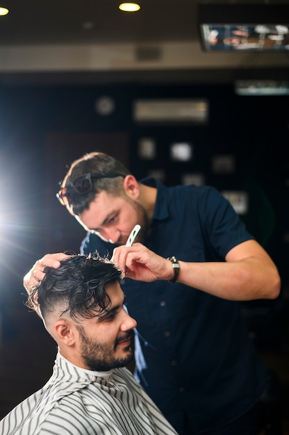 Hair stylist giving client a fresh haircut