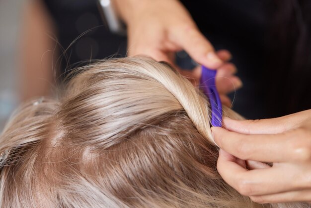 Hair stylist makes bouffant using comb on thin strands Shatush technique for hair lightening