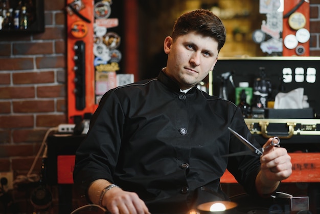 Hairdresser in barbershop chair with tools