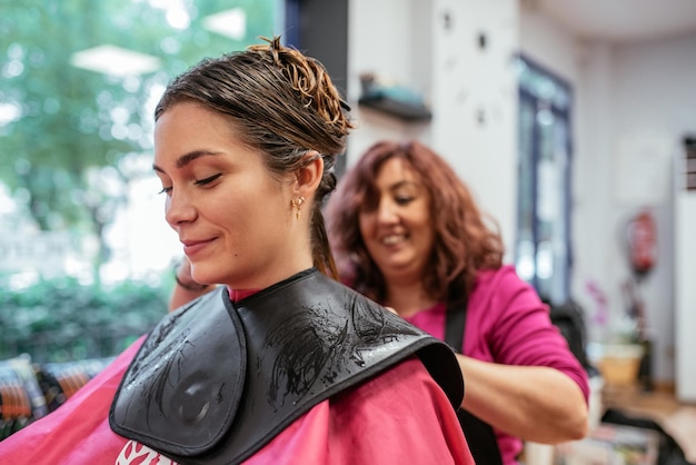 Hairdresser combing woman39s hair