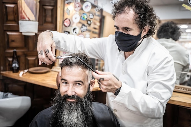 Hairdresser cutting the hair of a man in a salon