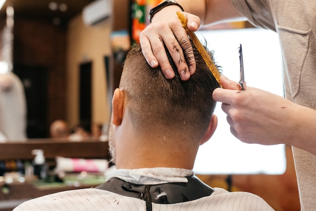 Hairdresser doing hairstyle and style with scissors and comb