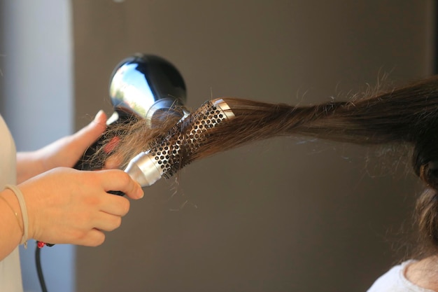 Hairdresser dries the hair in a beauty