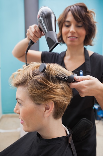 Hairdresser drying a customers hair