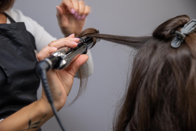 a hairdresser makes a woman's hair in a spa salon