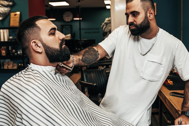 Hairdresser serving a client in a barbershop