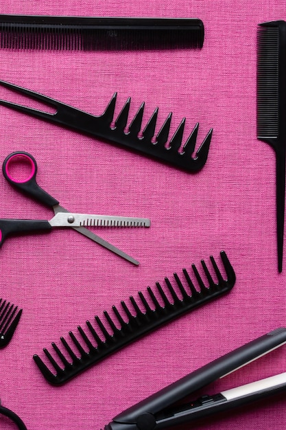 Hairdresser set of different objects on pink background