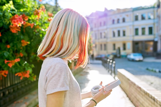 Hairstyles hairs fashion trends coloring Closeup of teenager girl's head with multicolored dyed hair complex coloring profile view