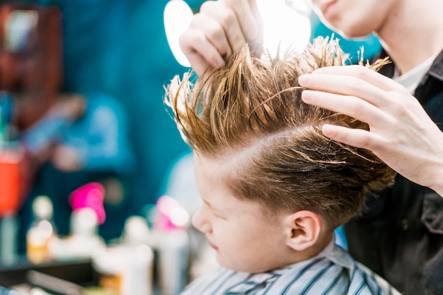 A hairstyling of a little blond guy