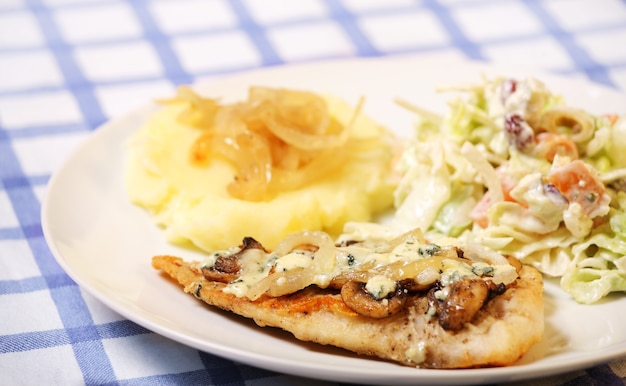 hake fish baked with mushrooms served with potatoes and salad