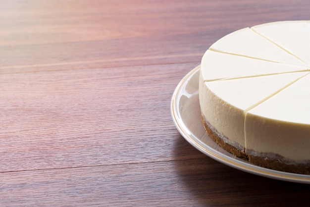 Half cream cake on wood table