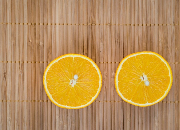 Half cut orange texture on wooden table.