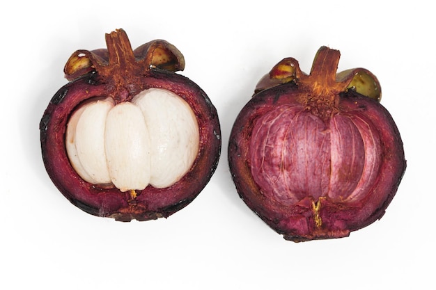 Half cut sliced fresh organic mangosteen fruit with peel top view isolated on white background