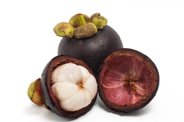 Half cut sliced and whole fresh organic mangosteen fruit with peel isolated on white background