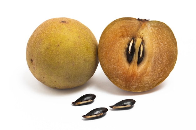 Half cut and whole fresh organic sapodilla delicious fruit with seeds isolated on white background