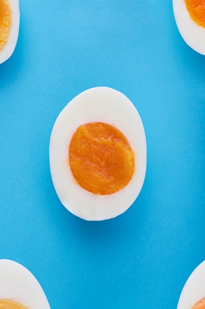 Half egg on a blue background seen from above. Top view