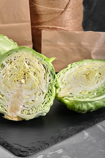 Half of fresh cabbage on dark background