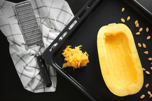 Half of fresh spaghetti squash on baking sheet