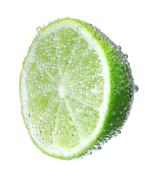 Half a lime green in bubbles, isolated on white