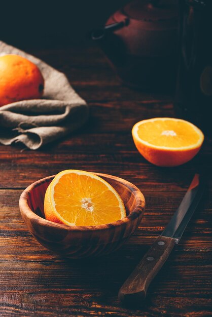 Half of orange in a wooden bowl