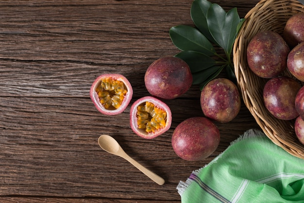 Half of  passion fruit and organic passionfruit on wood basket