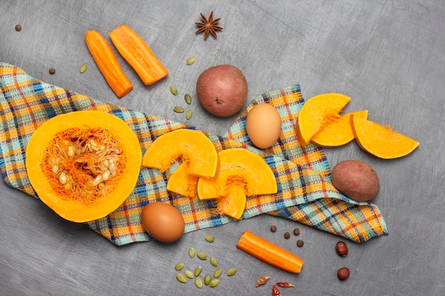 Half pumpkin and sliced pieces of pumpkin on napkin