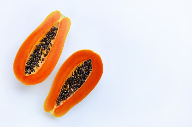 Half of ripe papaya fruit with seeds isolated on white background